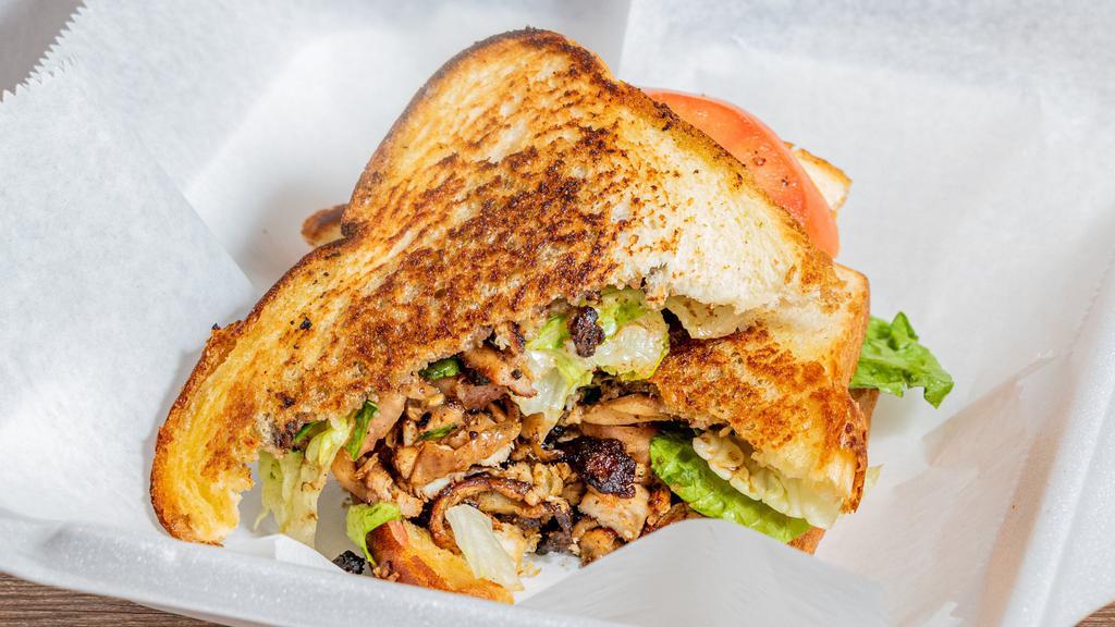 Jerk Chicken Sandwich · Choice of chicken or vegan crumbles on toasted artisan bread, topped with lettuce, tomato, and jerk sauce.