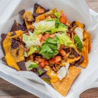 Jerk Chicken Nachos · Choice of chicken or vegan crumbles, lettuce, tomato, beans, jalapeños, topped with cheese o...