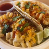 Mac & Cheese Taco · Carnitas, topped with crushed doritos and spicy mac and cheese drizzled with a bourbon barbe...