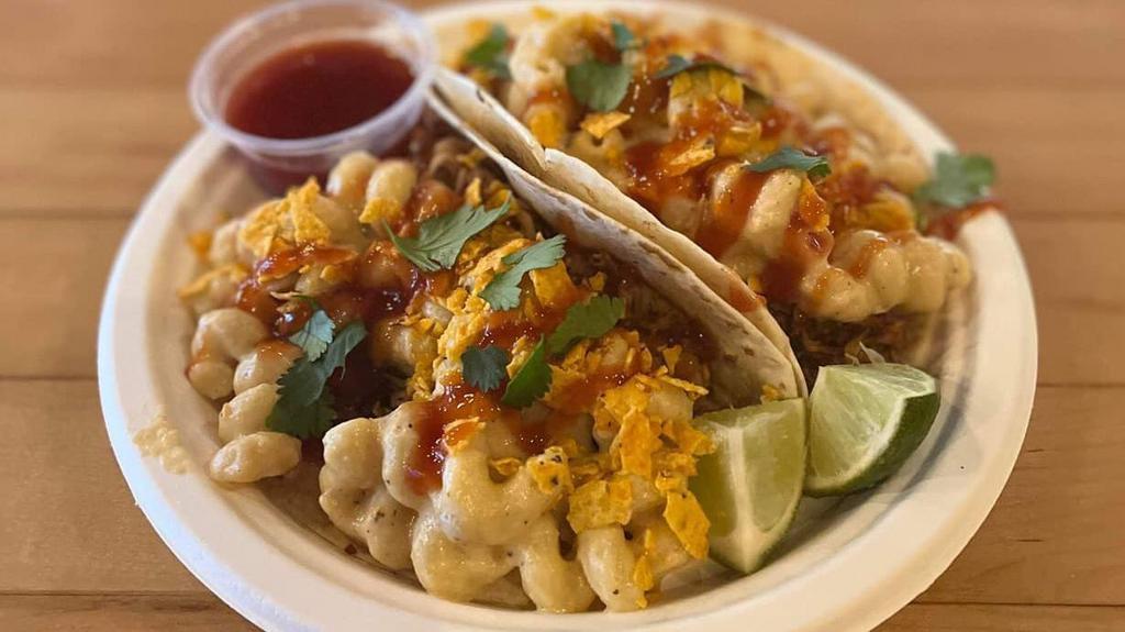Mac & Cheese Taco · Carnitas, topped with crushed doritos and spicy mac and cheese drizzled with a bourbon barbecue sauce.