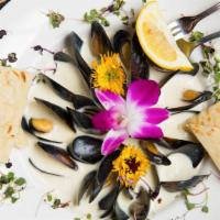 Mussels · Mussels steamed in white wine, garlic and herbs.