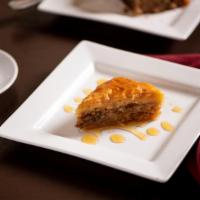 Baklava · Crispy rolls of phyllo dough topped with pistachios and honey.