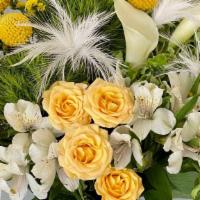 Make Me Shine · A delicate mix of white and yellow flowers.