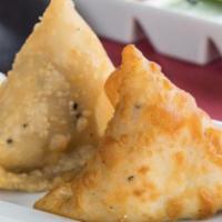 Samosa · Crispy triangular pastry turnover filled with chicken or vegetables.