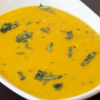 Tadka Dal · Fresh yellow lentils cooked with garlic, ginger, tomato, fresh herbs & spices and with pinch...