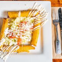 Flautas · 4 chicken corn fried, rolled taquitos, topped with lettuce, sour cream, queso fresco and tom...