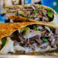 Cheese-Steak Burrito · A flour tortilla rolled and stuffed with skirt steak, grilled bell peppers, onions and shred...
