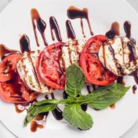 Caprese Salad · Ripe tomatoes, fresh mozzarella, basil, and extra virgin olive oil.