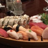 Boat For 1 · Six pieces of sushi, twelve pieces of sashimi, and California roll.