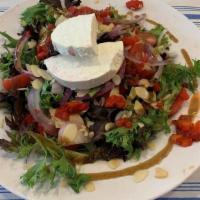 Manouri Mixed Green Salad · Mixed Greens, Cherry Tomatoes, Red Onions, Roasted Red Peppers, Almonds, Grilled Manouri che...