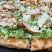Grilled Chicken Caesar Pizza · Brushed olive oil, grilled chicken, shaved romaine, caesar dressing mozzarella, shaved Parme...