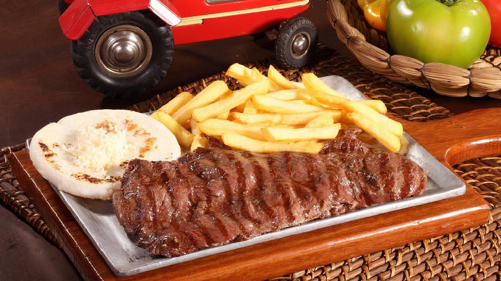 Carne Asada / Grilled Steak · Carne asada servida con papa francesa y arepa con queso/ Grilled meat served with fries and arepa with grated cheese