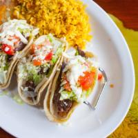 Tacos Al Carbon · Two Soft tacos made with juicy tender chunk skirt steak, or chicken pieces, lettuce, tomato ...