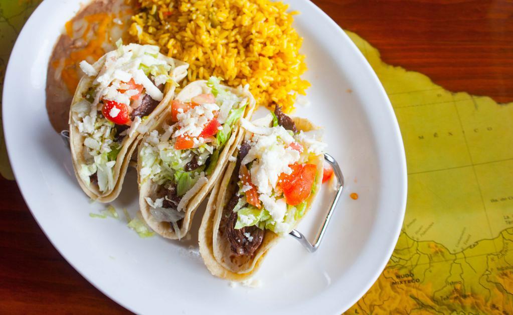 Tacos Al Carbon · Two Soft tacos made with juicy tender chunk skirt steak, or chicken pieces, lettuce, tomato and guacamole. Served with yellow rice and beans.
