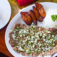 Palomilla · Seasoned top sirloin steak pounded thin, topped with chopped sweet onions, parsley and garni...