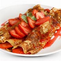 French Crepes · Rolled with fresh strawberries and served with warm strawberry syrup and powdered sugar.