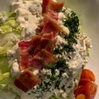 Wedge Salad · With crispy bacon, bleu cheese crumbles and house made bleu cheese dressing. May contain raw...