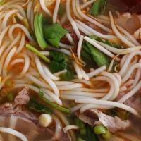 Bun Bo Hue / Hue Spicy Rice Noodle · Pig knuckle, sliced pork, beef flank and ground pork cake.