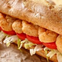 Shrimp Po-Boy · Served with tomato, lettuce, pickles, and remoulade sauce on French bread along with French ...