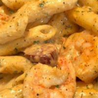Seafood Pasta · Featuring Alfredo Sauce, Spicy Cajun shrimp, Andouille Sausage, Crawfish