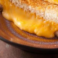 Grilled Cheese Sandwich · Yellow American Cheese Layered Between Two Slices Of Grilled White Bread