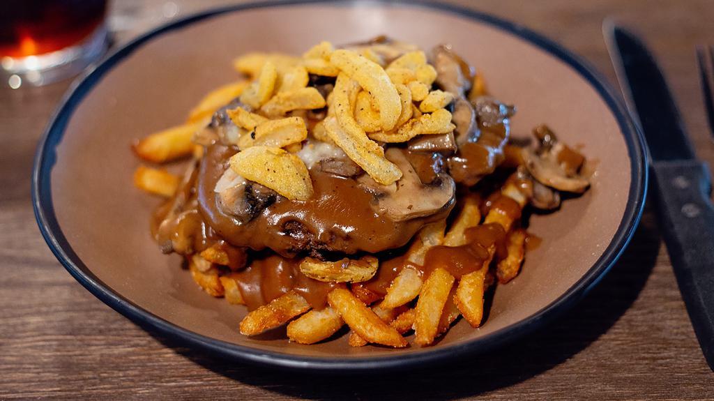 Hamburger Steak · Our signature hamburger steak seasoned & grilled; served on top of your choice of house fries or creamy mashed taters. Then smothered in our rich brown gravy, caramelized mushrooms & fried onion bites .