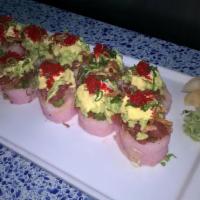 Flaming Toro Roll · Spicy hamachi, cilantro, jalapeno, and avocado topped with tuna, tempura flakes, and tobiko ...