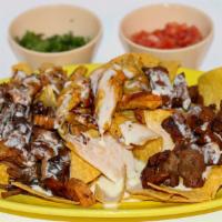 Nachos · Nachos with choice of steak, carnitas or grilled chicken, topped with cheese dip.