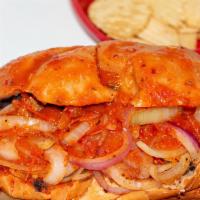 Tortas Ahogadas (Drowned Tortas) · Mexican bolillo bread filled with carnitas, black refried beans, topped with fresh onions an...