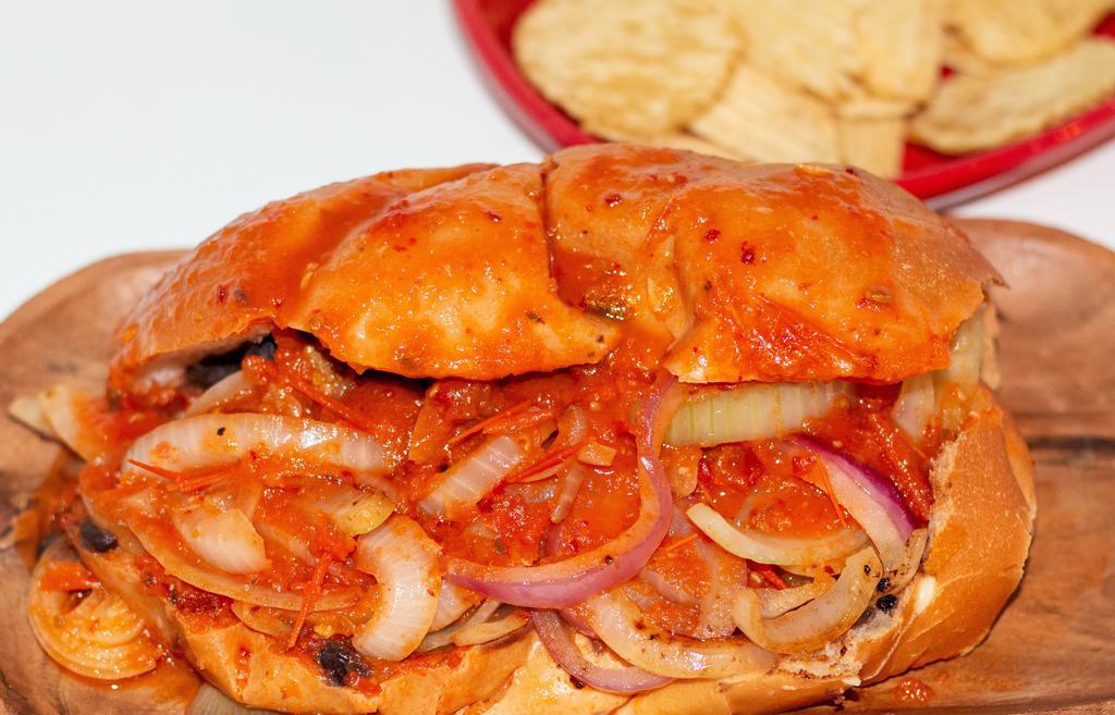 Tortas Ahogadas (Drowned Tortas) · Mexican bolillo bread filled with carnitas, black refried beans, topped with fresh onions and Castillo real adobo sauce. Served with homemade potato chips or corn chips.