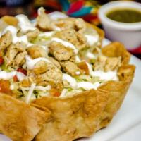 Fajita Taco Salad · A crispy flour tortilla shell filled with chicken or steak, grilled with bell peppers and on...