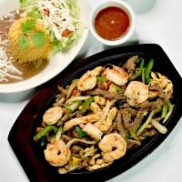 Fajitas · Lola’s fajitas steak, chicken and shrimp, served with onions bell peppers, rice, beans and t...