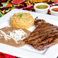 Rib Eye (10 Oz) · Grilled to order rib eye steak, side of rice, beans and three tortillas corn or flour.