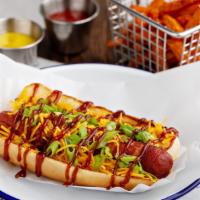 Memphis Dog · Bacon-wrapped hot dog, topped with shredded cheese, BBQ sauce, and green onions.