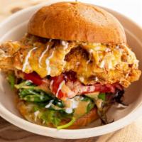 Bread & Bird-Breaded · Breaded or grilled chicken, Pepper Jack, greens, tomato, red onion, featherweight sauce.