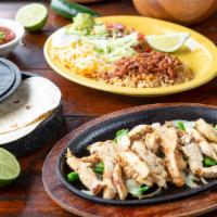 Chicken Fajitas* · Tender marinated chicken served on a sizzling skillet with freshly grilled onions and pepper...