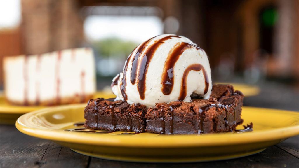 Brownie Delight · Warm chunky chocolate brownie served with a scoop of vanilla ice cream, drizzled with chocolate syrup.