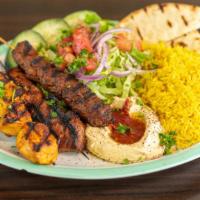 Beef Shish Kabob · Grilled tender meat well marinated over night, hummus spread, lettuce, tomatoes, onion, pick...
