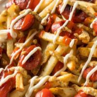 Salchi Papas / Loaded Fries · Topped with sausages, fresh cilantro, flaco's special sauces, fresh cheese.
