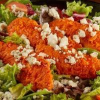 Buffalo Salad · Your choice of buffalo sauced tenders served on mixed greens, prepared with bleu cheese crum...
