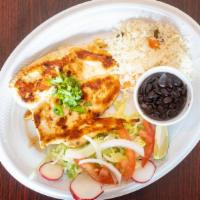 Pechuga A La Plancha · Grilled chicken breast served with rice, black beans, salad, and tortillas.