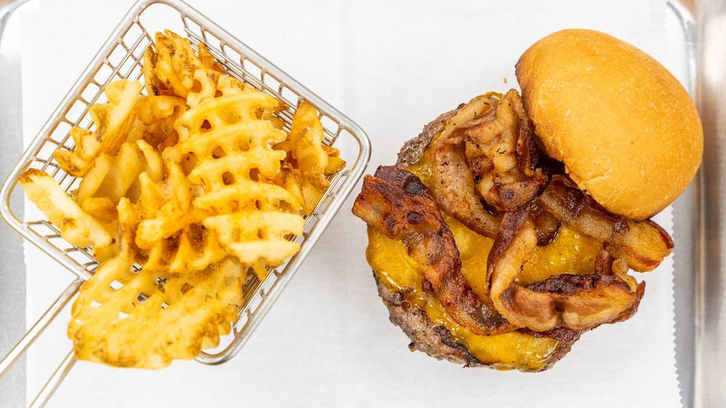 Classic Cheddar & Bacon Burger · Applewood bacon & Cheddar burger on brioche bun with seasoned waffle fries.