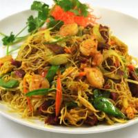 Singapore Rice Noodles · Curry flavored stir fried rice noodles with roast pork and shrimp.