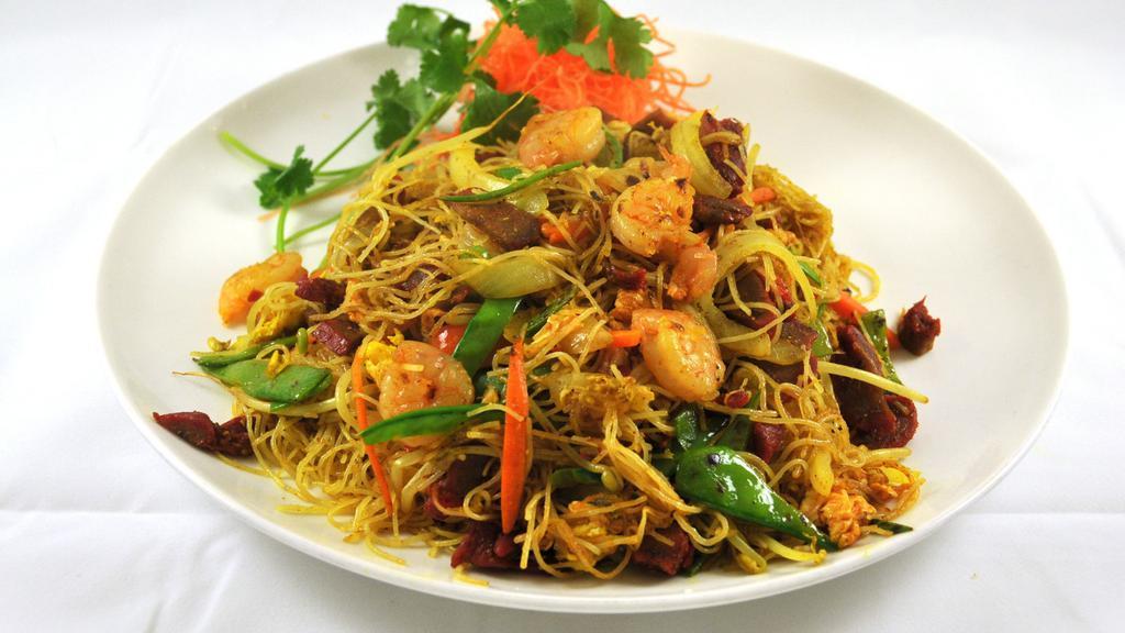 Singapore Rice Noodles · Curry flavored stir fried rice noodles with roast pork and shrimp.