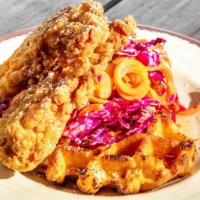 Lincoln Rd Chicken & Waffles (Served All Day) · Belgian waffle topped with fried breaded chicken tenders, our house sassy sauce, syrup sauce...