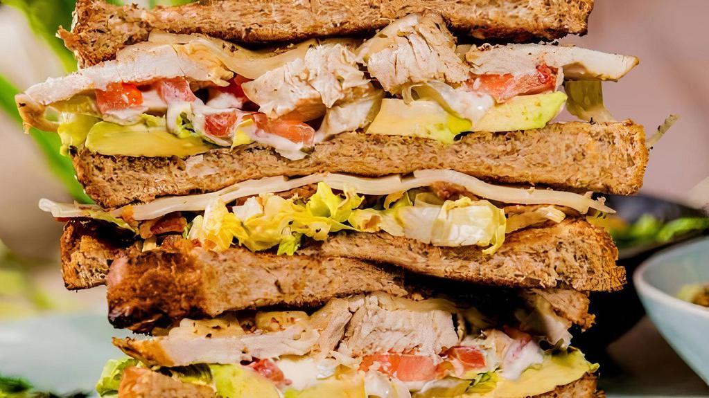 Chicken Club Sandwich · Sliced multi-grain bread, Swiss cheese, bacon, tomato, avocado, lettuce, and aioli dressing.