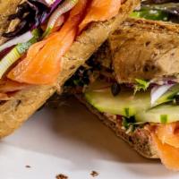 Salmon · Multigrain baguette, dill cream cheese, cucumber, red onions, capers, mixed greens.