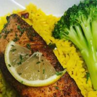 Salmon Over Yellow Rice Side Broccoli · Pan seared salmon over yellow rice and side steam broccoli.