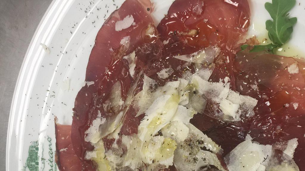 Bresaola E Scaglie Di Parmigiano · sliced cured italian style beef served with rugula and topped with parmigiano reggiano shaved adrezed wit olive oil salt black pepper and lemon