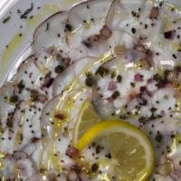 Carpaccio Di Pólipo · Cooked thin sliced octopus, onions, capers, parsley, drizzled with extra virgen olive oil, l...